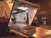 Side view of the bow ramp. Notice two things: One, the panel in the middle - this would normally be laid down by ground crew in the gap between the ramp's end and the ground, to allow smoother transition for embarking cars, especially those with a lower wheel base. Secondly, the yellow hydraulic ram in the foreground at the edge of the ramp. This was used to retract and extend the lip of the ramp. During flight, this lip is folded 90&deg; to the ramp for the whole mechanism to fit snugly into the superstructure.